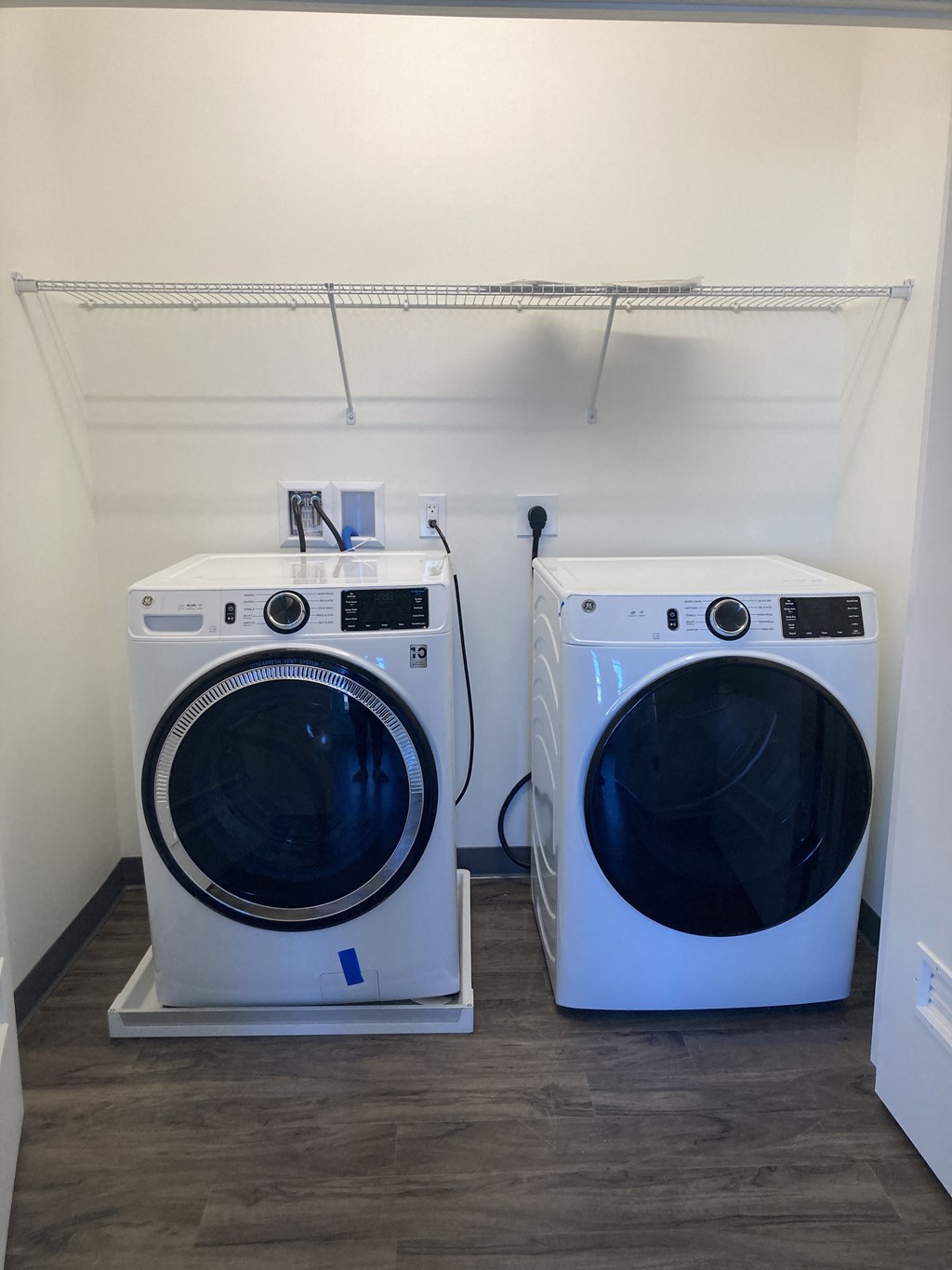 a washing machine and a dryer in a laundry room