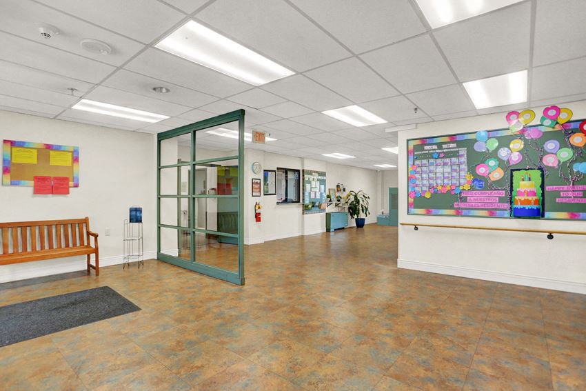a large room with a large projection screen on the wall and a bench in front of a
