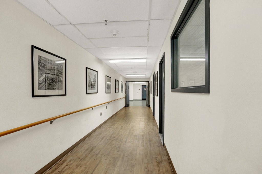 a long corridor with framed photographs on the walls