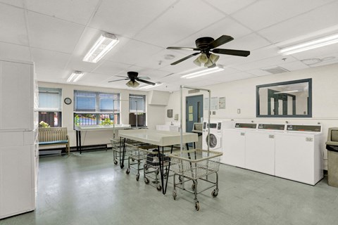 a kitchen with a table and chairs and two ceiling fans