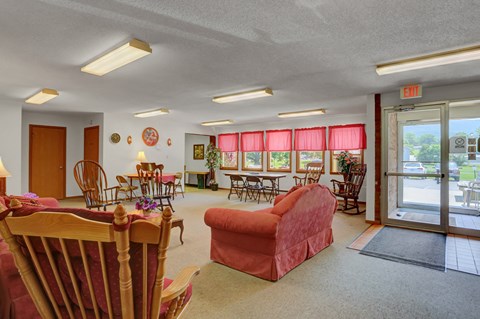 a living room filled with furniture and a glass door