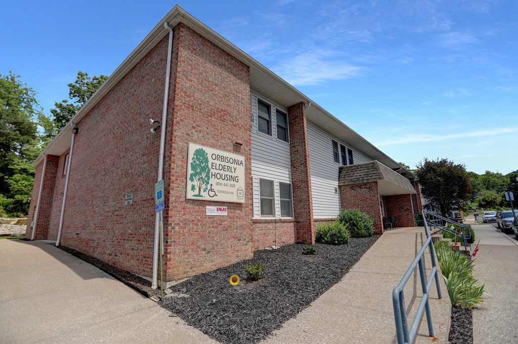 a brick building with a white sign on it