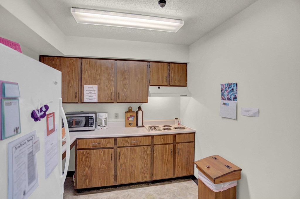 a kitchen with wooden cabinets and a white refrigerator