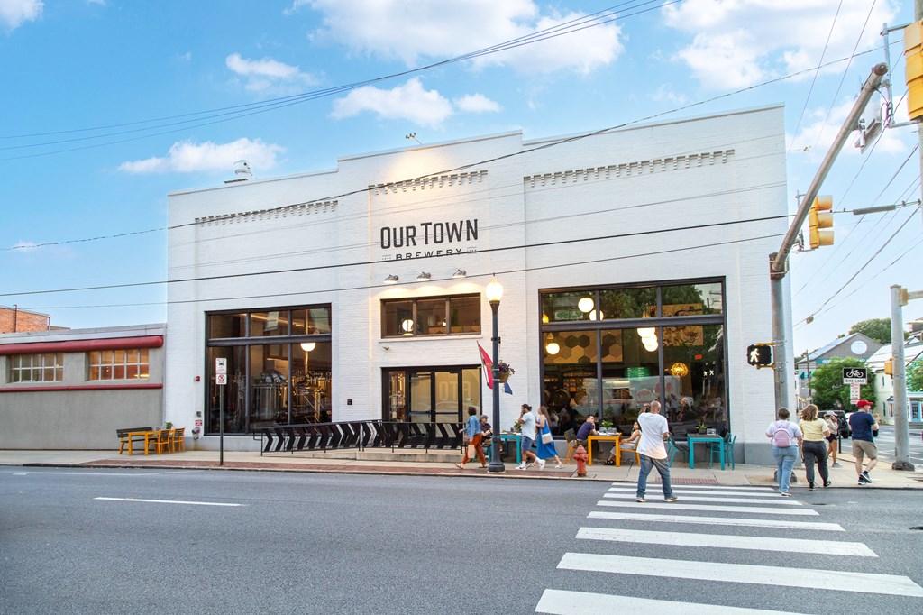 people walking outside of our town restaurant on a street corner