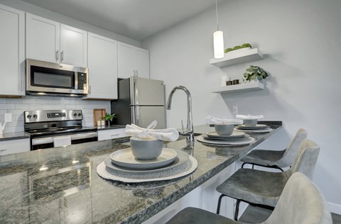 a kitchen with granite counter tops and stainless steel appliances