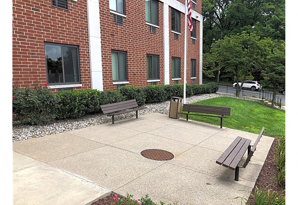 two benches in front of a brick building