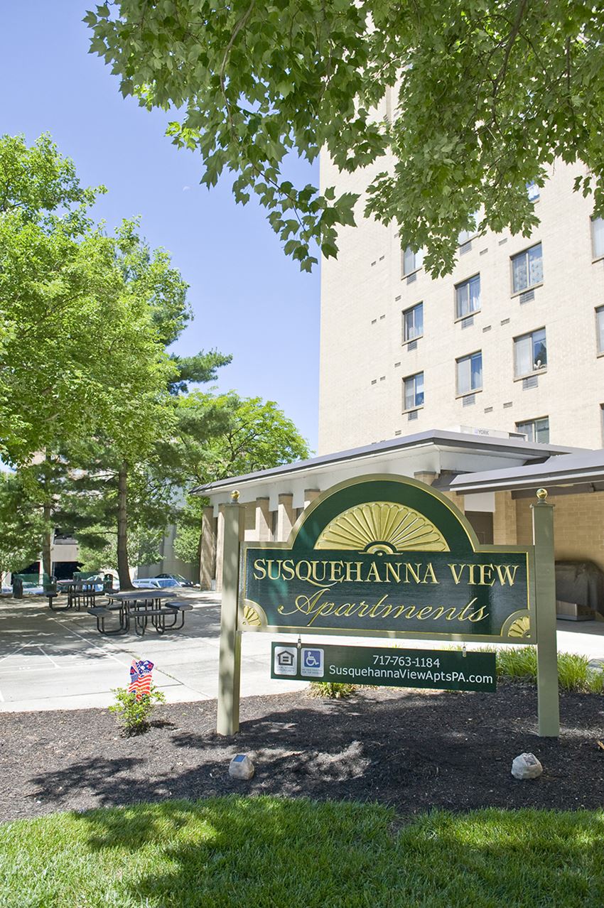 a sign for thessalonica view apartments in front of a building