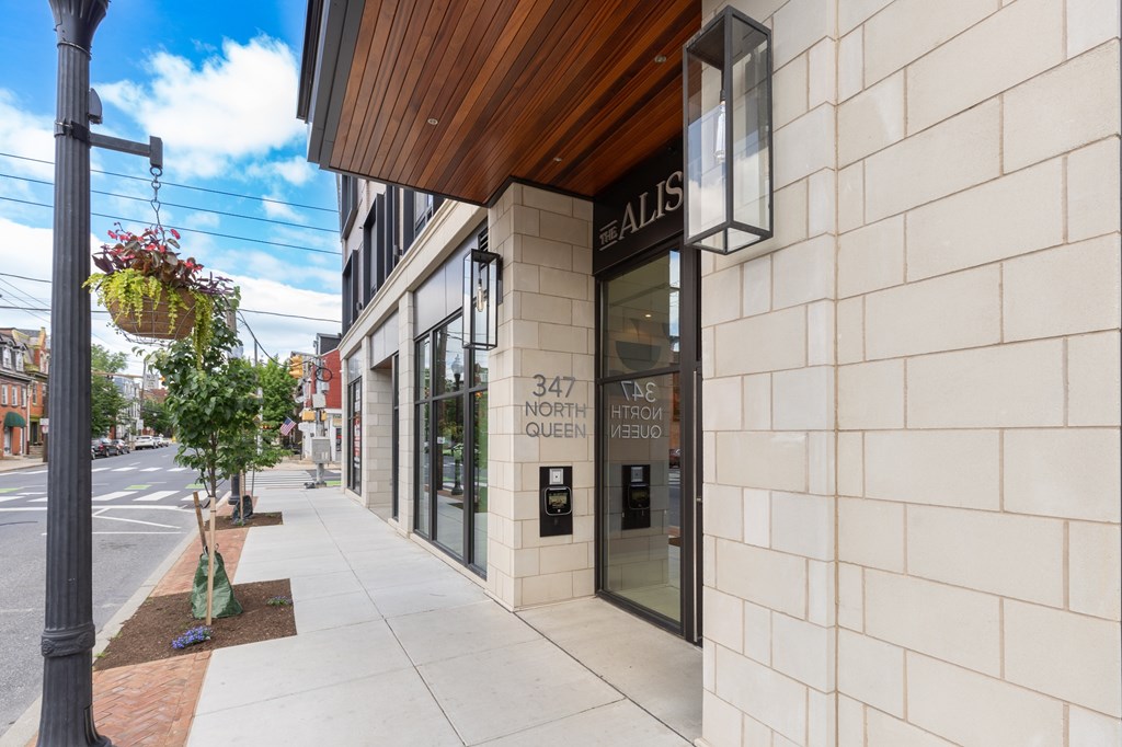 A street view of a building with a sign that reads "ALIS".