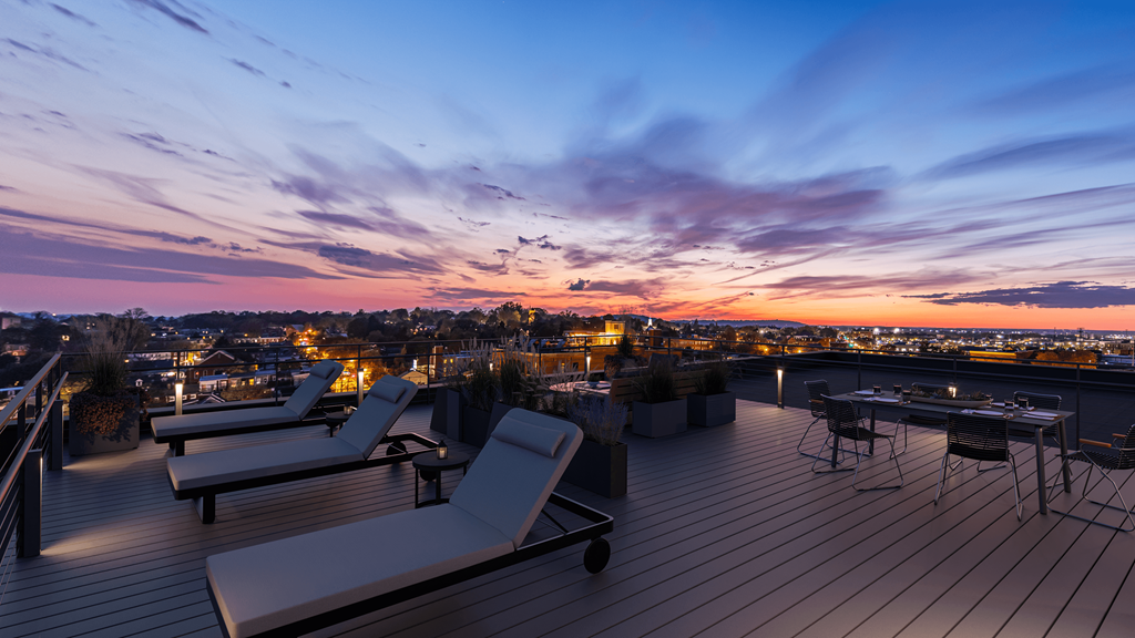 Apartments in Lancaster | a view of the city skyline from a rooftop terrace at sunset