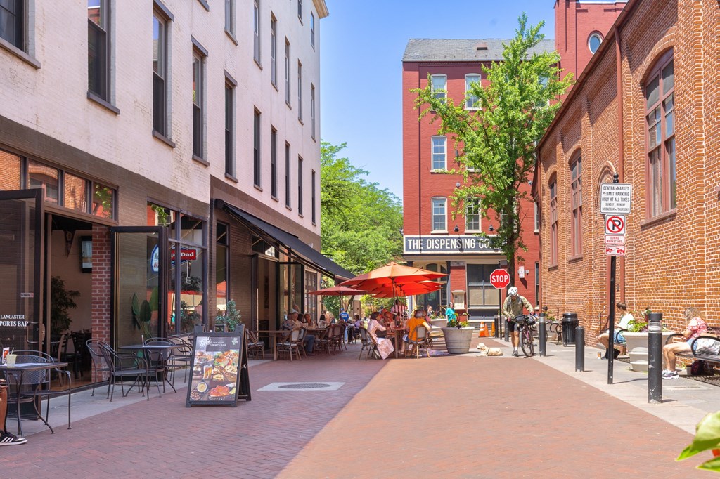 a city street filled with cafes and restaurants and buildings