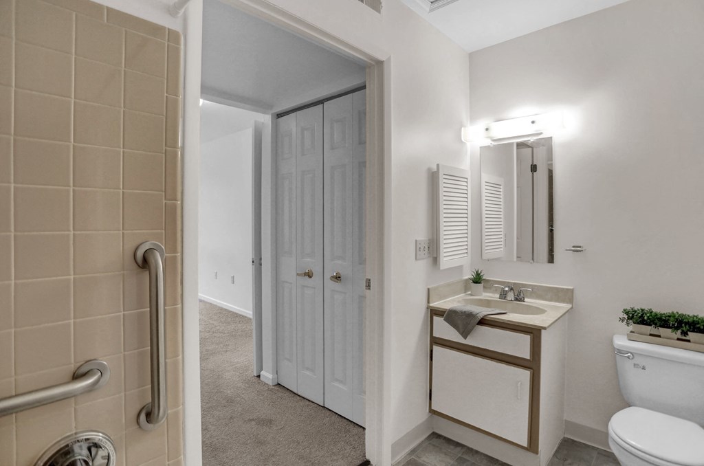 a bathroom with a toilet sink and shower
