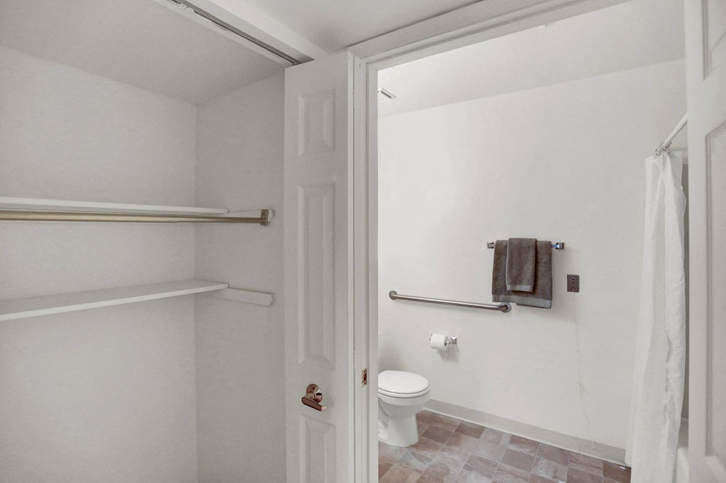 a bathroom with a toilet and a towel rack