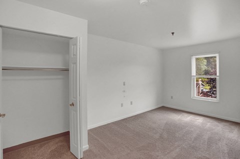 a bedroom with a closet and a window