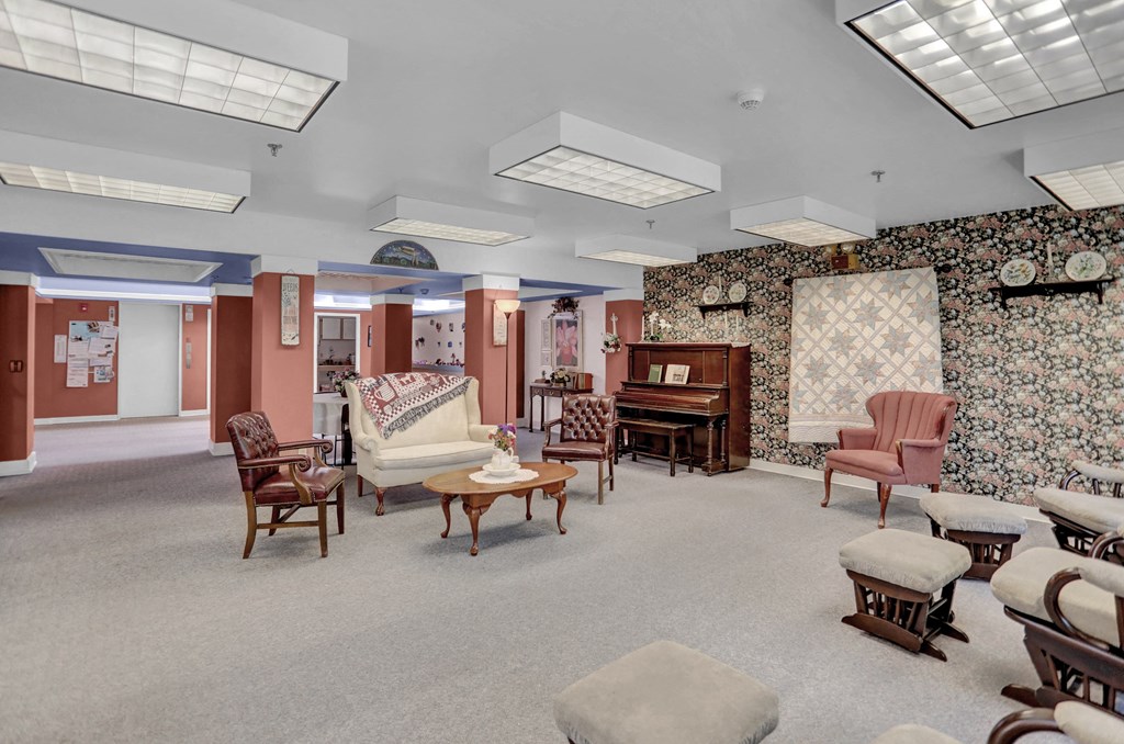 a living room filled with furniture and a piano