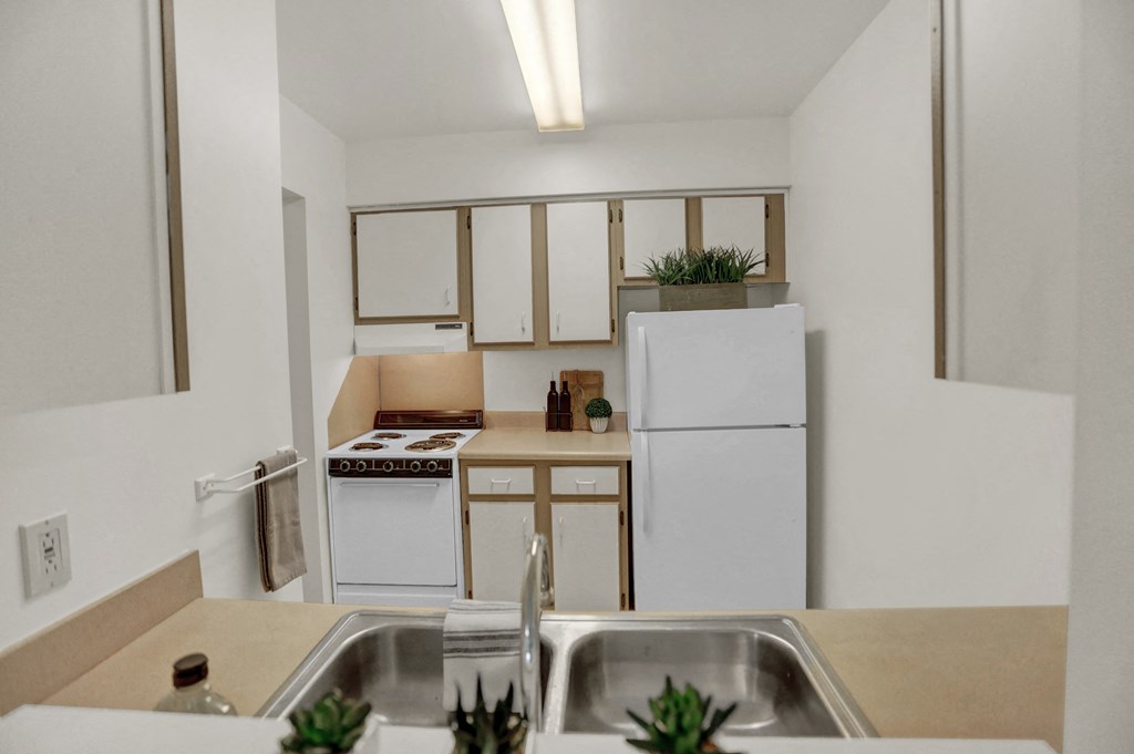 a kitchen with a sink and a refrigerator