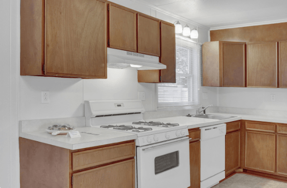 a kitchen with wooden cabinets and white appliances