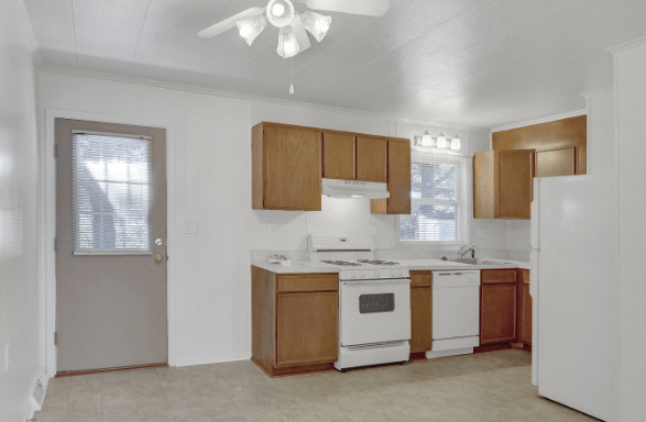 a kitchen with wooden cabinets and white appliances
