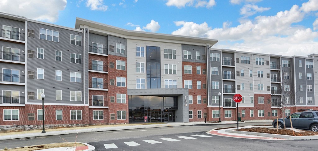 an exterior view of an apartment building on a city street