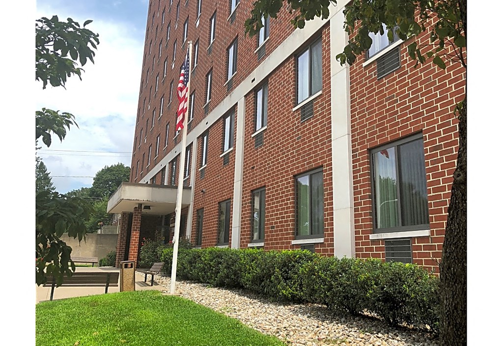 a brick building with an flag in front of it