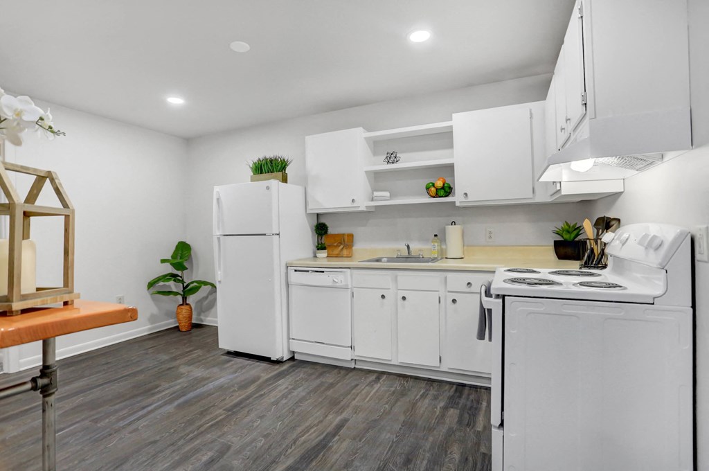 a white kitchen with white appliances and white cabinets