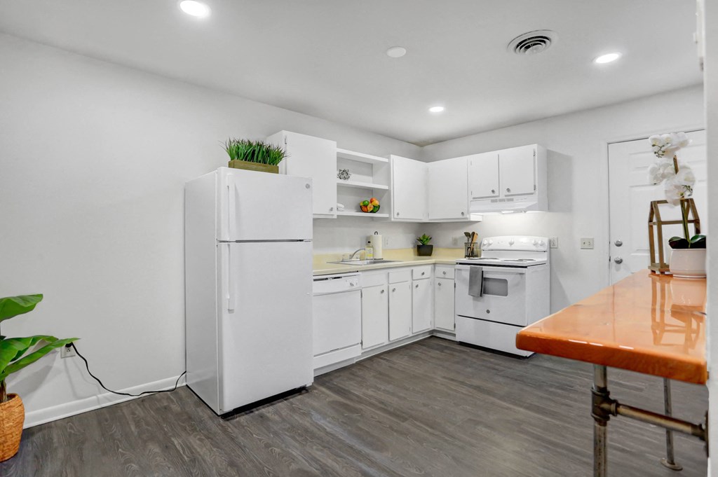 a white kitchen with white appliances and white cabinets