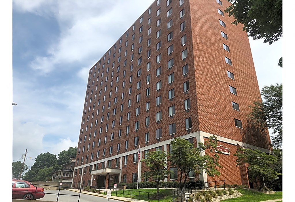 a tall brick building with a street in front of it