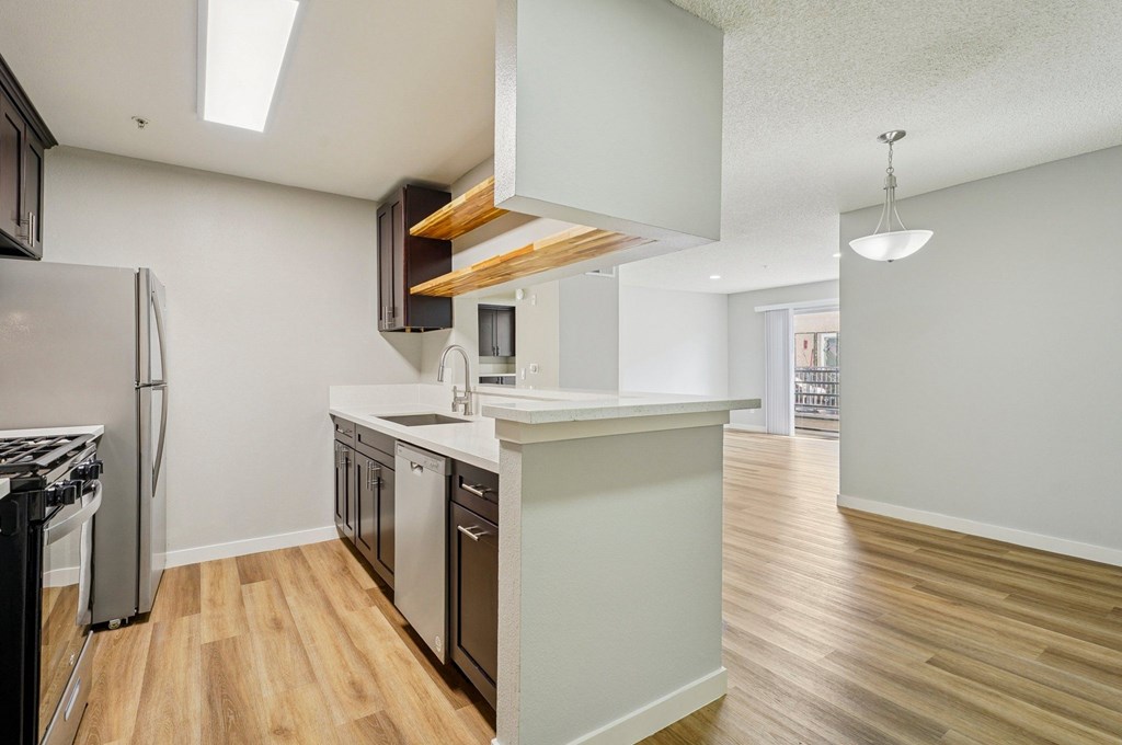 A kitchen with a refrigerator, stove, and oven.