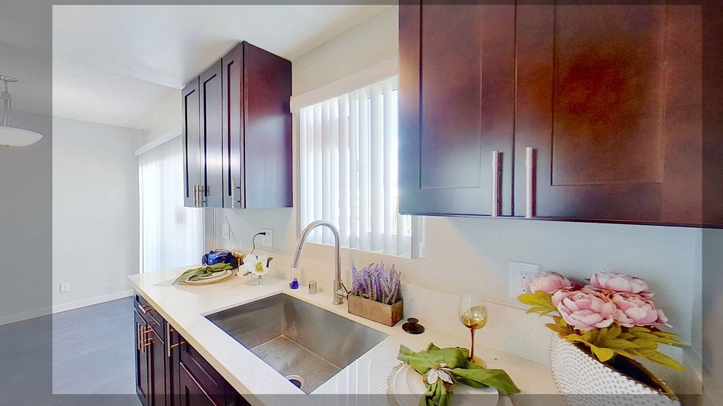 a kitchen with a sink and wooden cabinets