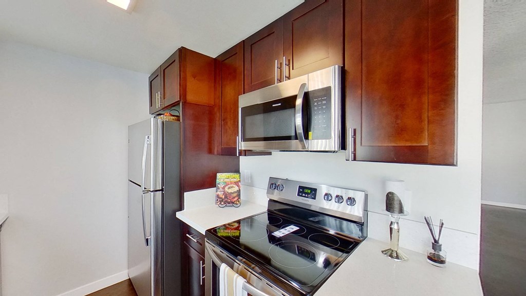 a kitchen with stainless steel appliances and wood cabinets