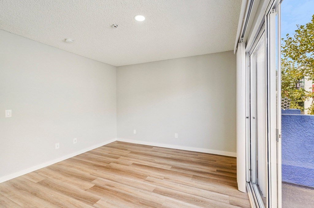 A room with a wooden floor and white walls.