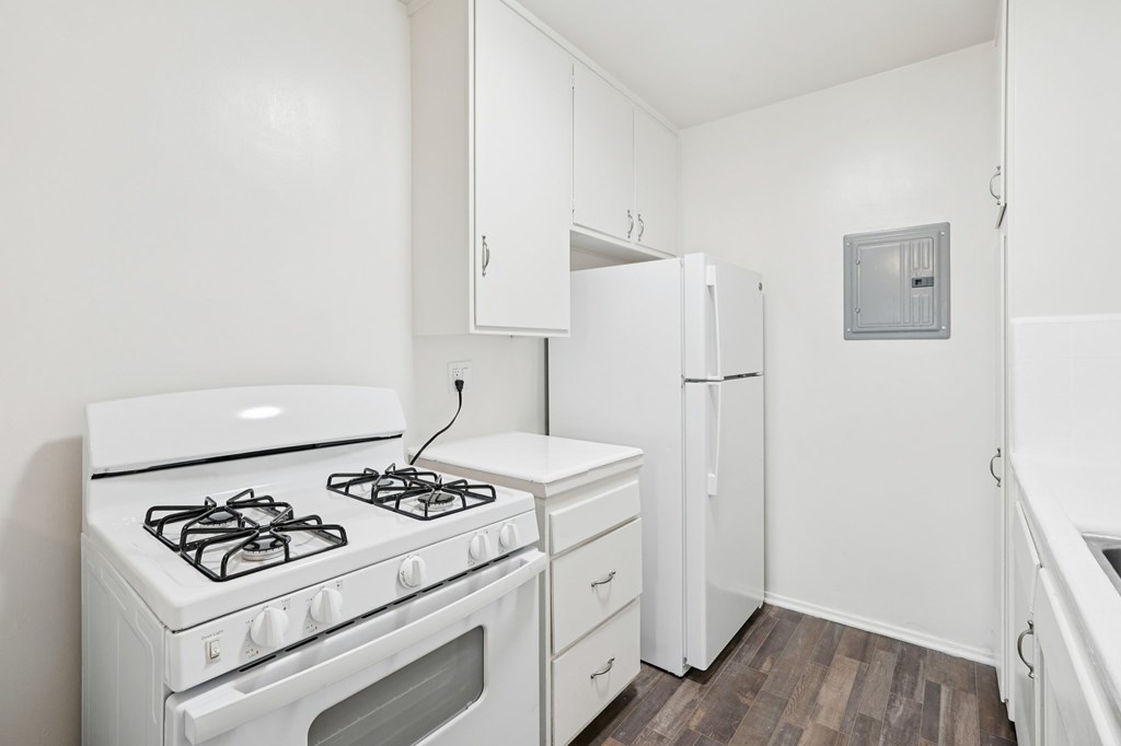 A white stove and refrigerator in a small kitchen.