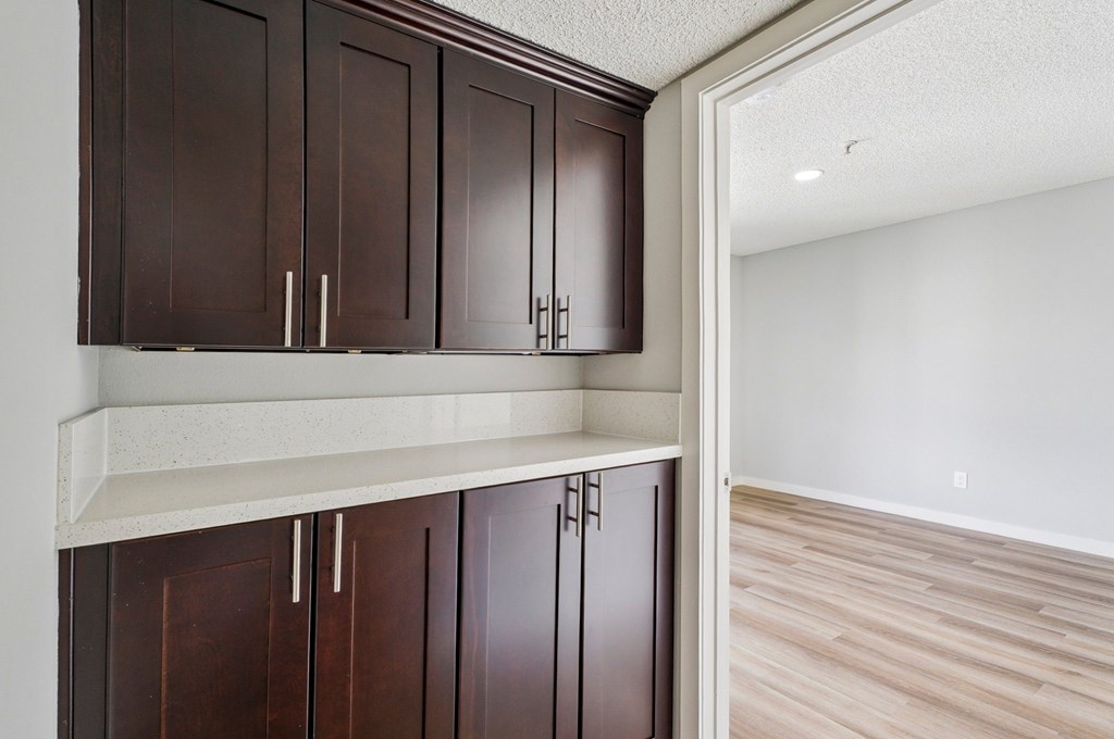 Brown cabinets with silver handles in a kitchen.