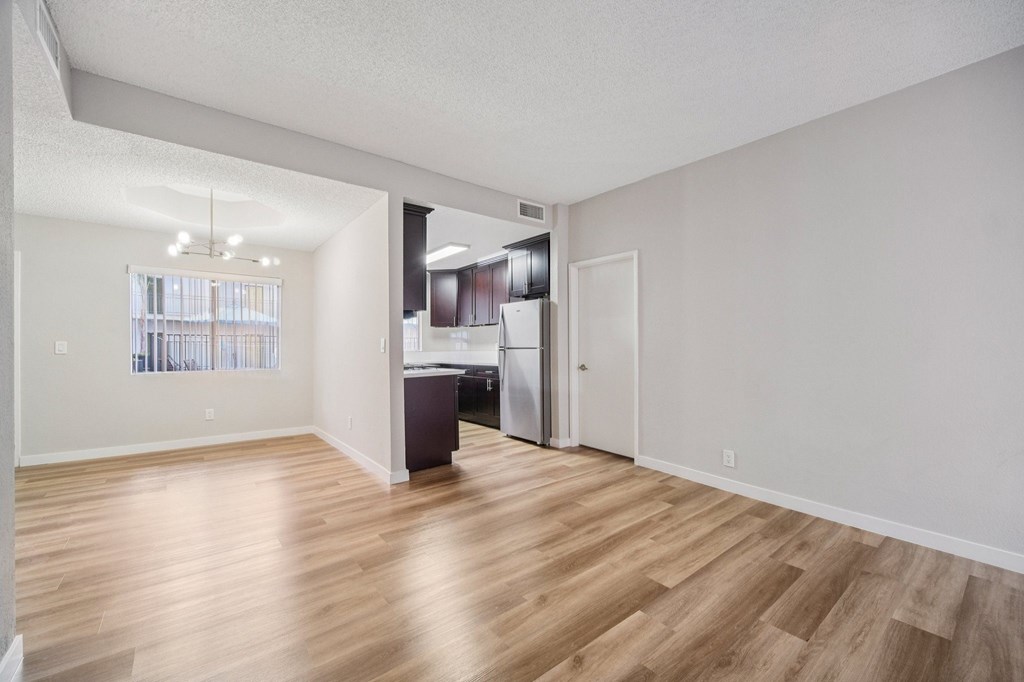 A kitchen area with a refrigerator and a countertop.