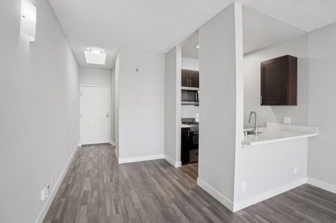 A kitchen with a white counter and a sink.
