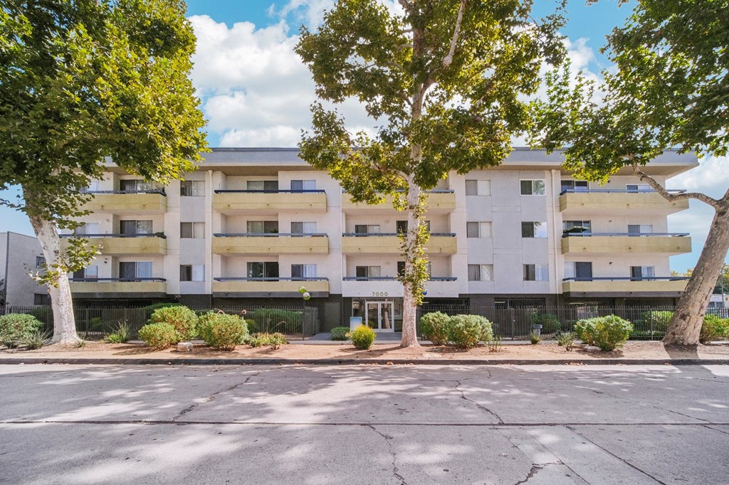 Apartment building with trees in front.