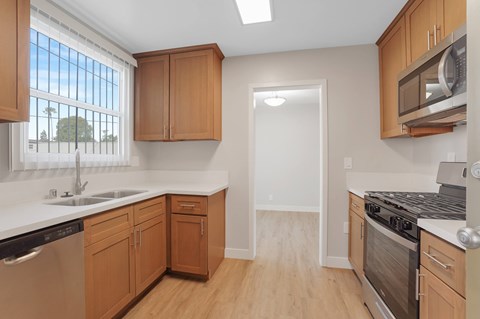 A kitchen with wooden cabinets and stainless steel appliances.