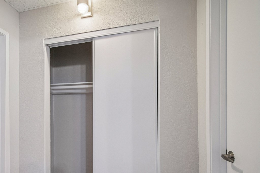 A white door with a glass window is slightly ajar.