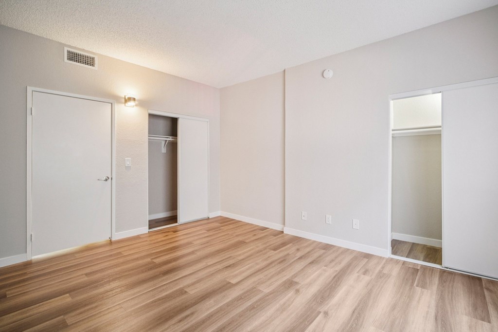 A room with a white door and a white wall.