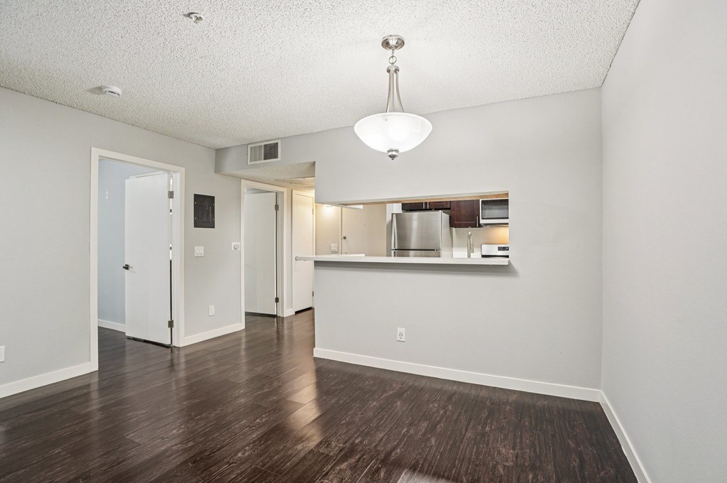 A kitchen area with a refrigerator, microwave, and oven.