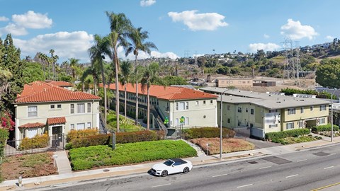 A white car is parked on the side of a street.