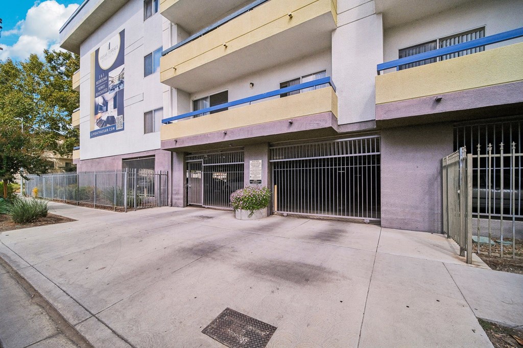 A white building with a blue stripe on the balcony.