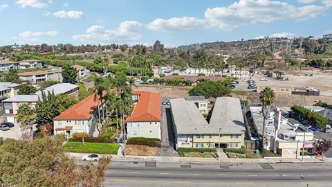 A view of a street with buildings on either side and a clear sky above.