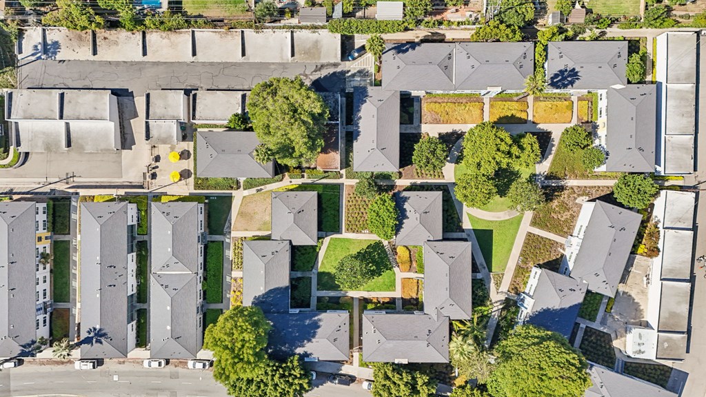 A bird's eye view of a residential area with houses and a park.
