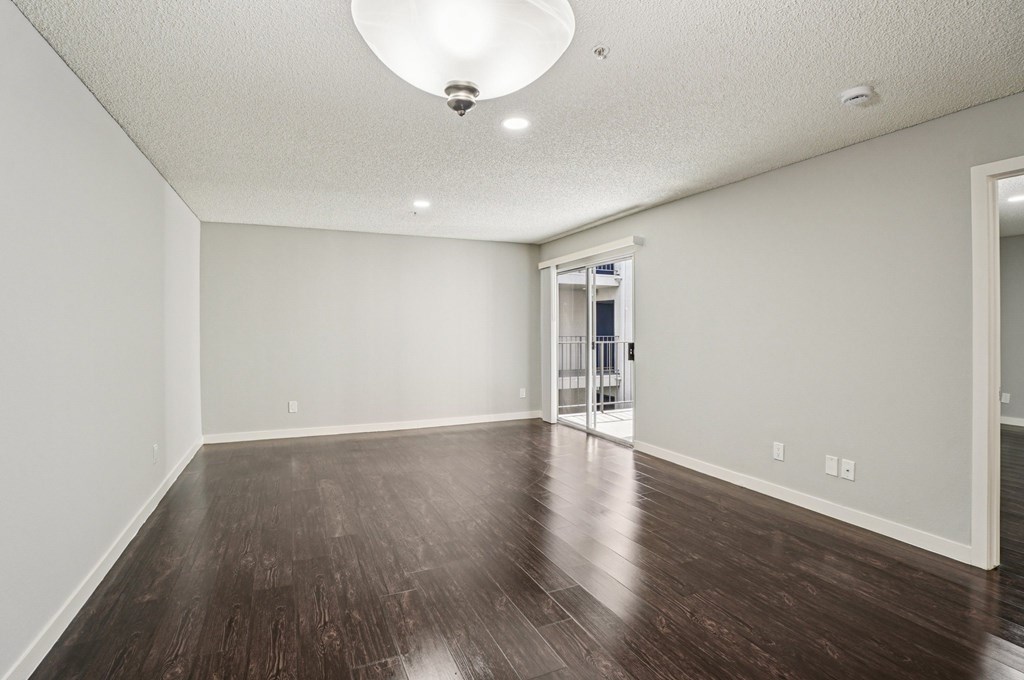 A room with a wooden floor and a white ceiling.