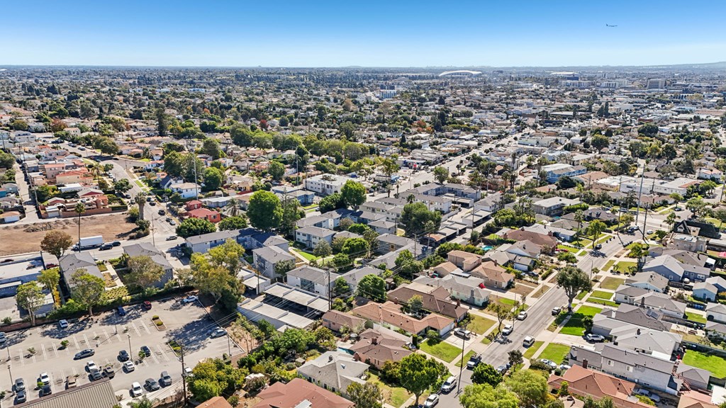 A bird's eye view of a residential area with houses and cars.