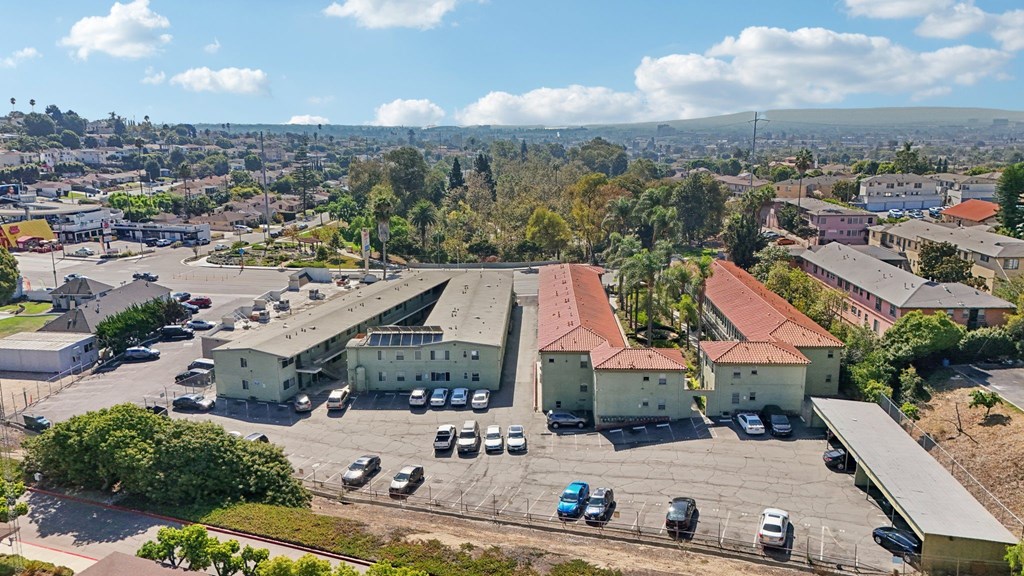 A parking lot with cars and a building in the background.