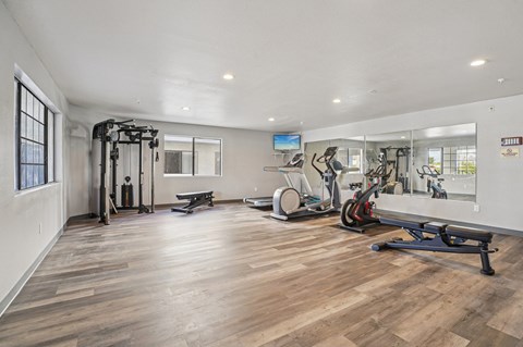 A spacious gym with a variety of exercise equipment.