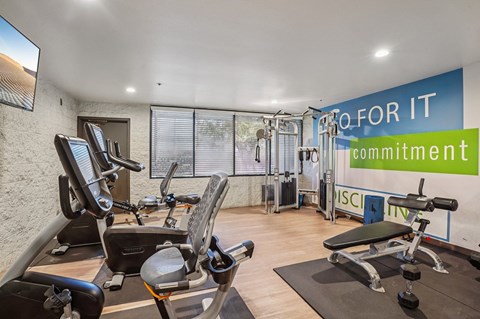 A gym with a sign that says "Go for it commitment".