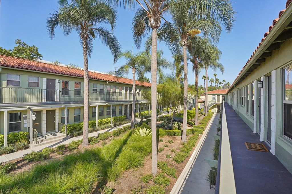 A row of houses with a blue pathway in between.