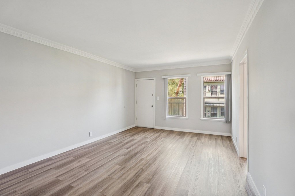 A room with a wooden floor and white walls.